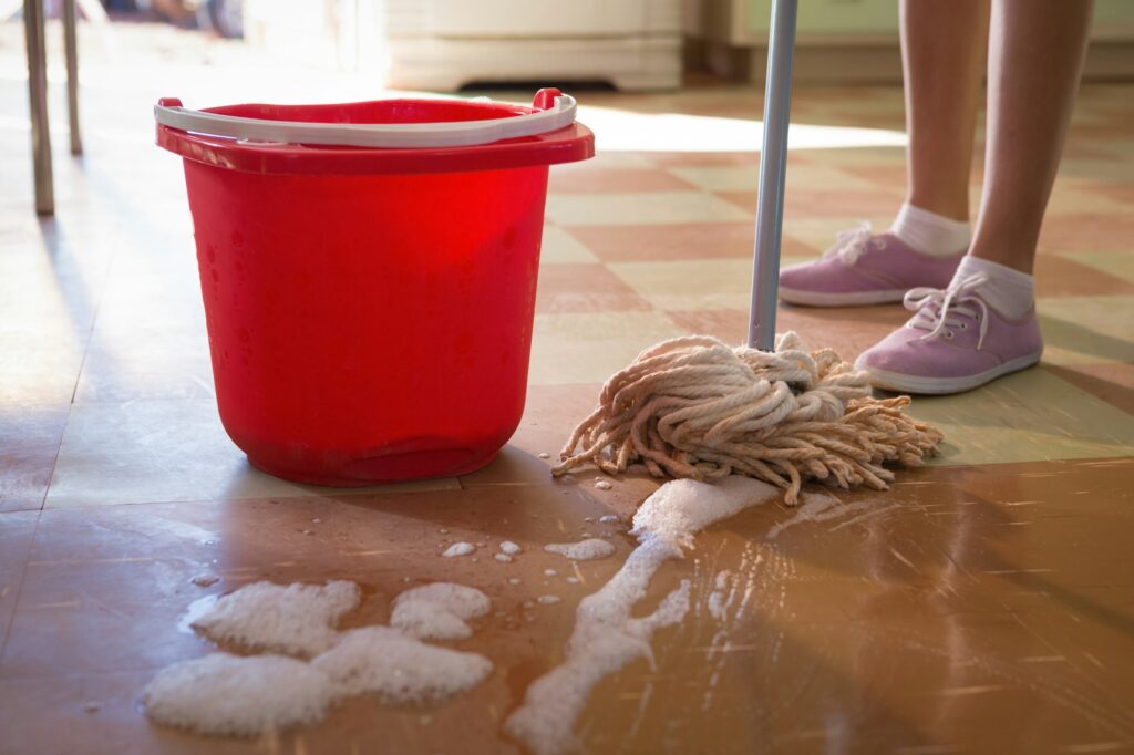 Waitress cleaning floor in restaurant